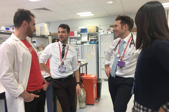 Group of people talking in a research laboratory