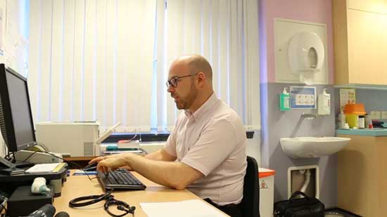 Doctor sitting at a computer