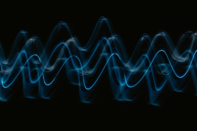 Multiple overlapping wave traces in shades of blue on a black background